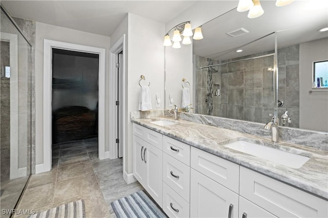 bathroom with double vanity, a stall shower, a sink, and visible vents