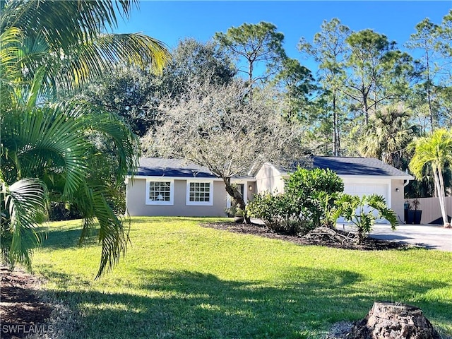 view of front facade featuring concrete driveway, an attached garage, a front lawn, and stucco siding