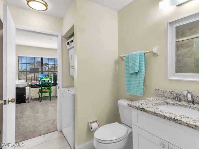 full bathroom with toilet, stacked washer and dryer, tile patterned flooring, and vanity