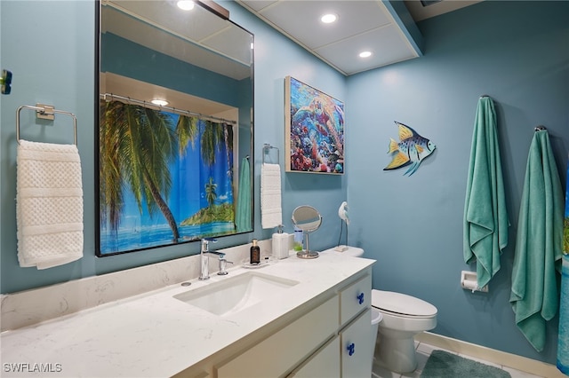 full bath with toilet, vanity, and recessed lighting