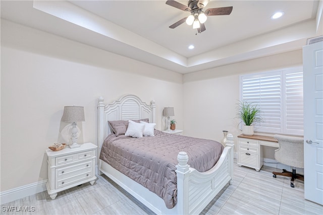 bedroom featuring recessed lighting, a tray ceiling, ceiling fan, and baseboards