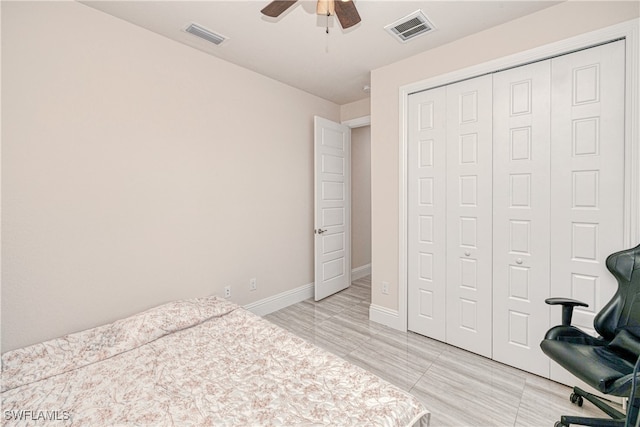 bedroom with a closet, visible vents, ceiling fan, and baseboards