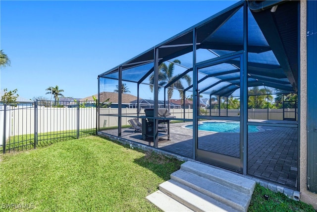 exterior space with a fenced in pool, glass enclosure, a patio, and a fenced backyard