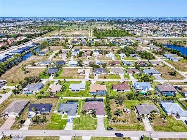 drone / aerial view featuring a water view and a residential view