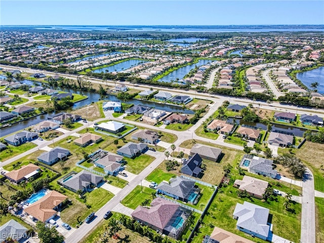 bird's eye view with a water view and a residential view