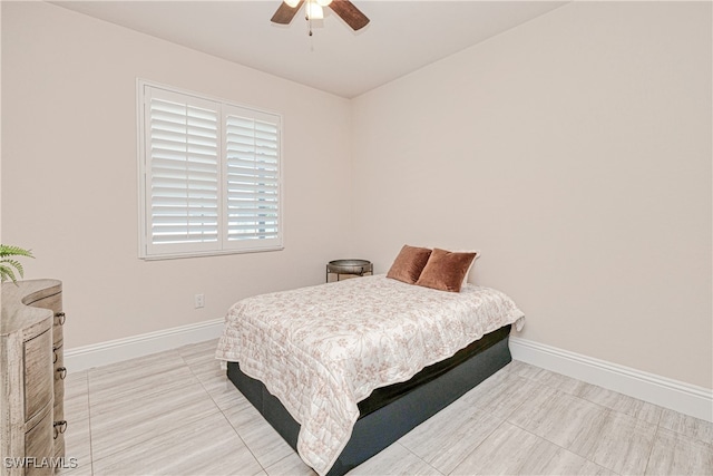 bedroom with a ceiling fan and baseboards