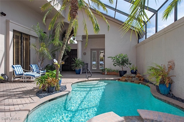 outdoor pool featuring a patio, a lanai, and fence