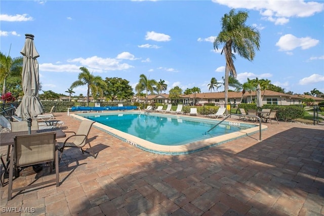 community pool featuring a patio area and fence