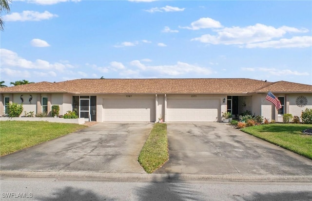 ranch-style house featuring a front yard, driveway, an attached garage, and stucco siding