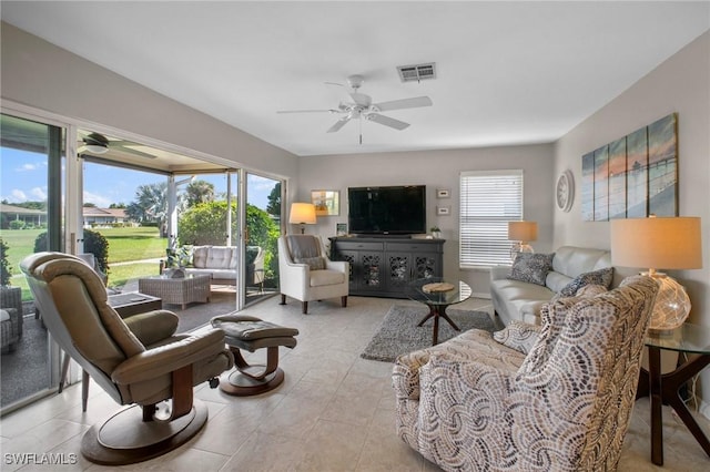 living area featuring visible vents, ceiling fan, and light tile patterned floors