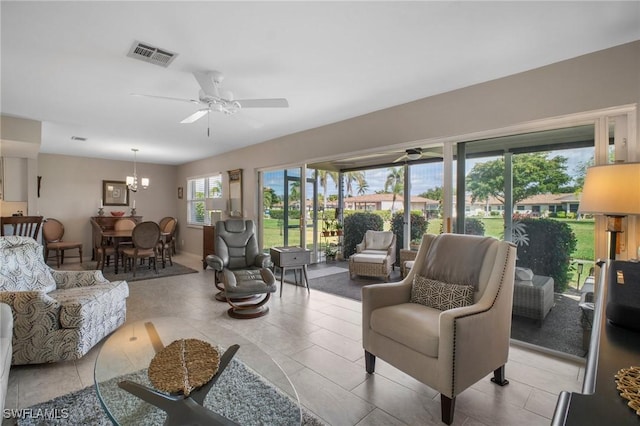 living room with visible vents, ceiling fan, and light tile patterned flooring