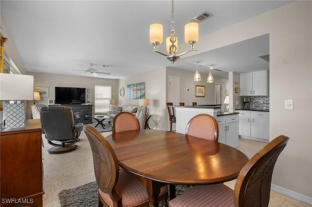 dining room featuring ceiling fan with notable chandelier and visible vents