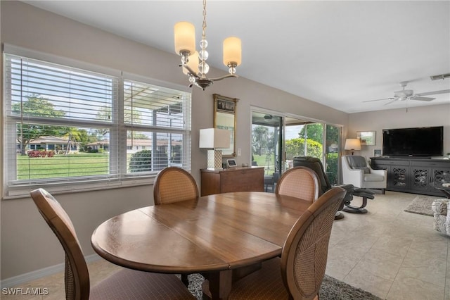 dining room with ceiling fan with notable chandelier, light tile patterned flooring, visible vents, and baseboards