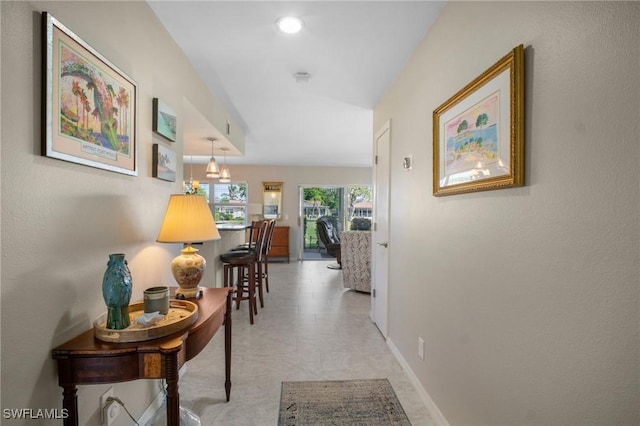 hallway with recessed lighting and baseboards