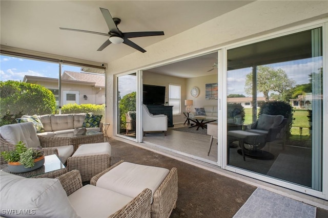 sunroom with a ceiling fan and a wealth of natural light