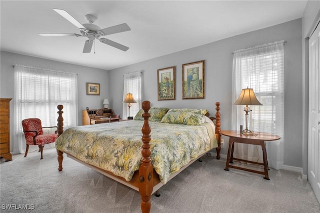 bedroom with carpet, multiple windows, and baseboards