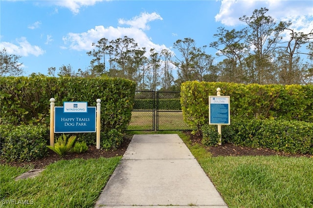 surrounding community featuring a gate and fence