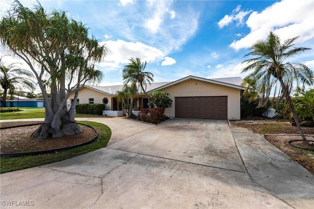 single story home featuring driveway and a garage