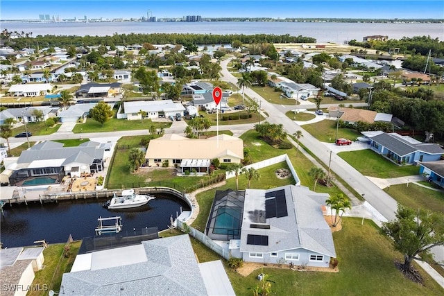 bird's eye view with a water view and a residential view