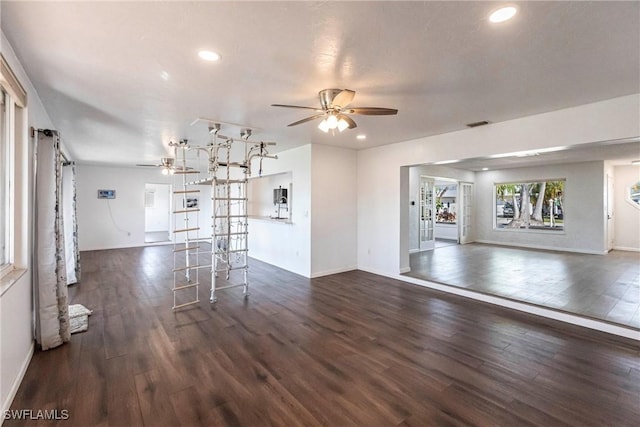 unfurnished living room with ceiling fan, dark wood finished floors, and recessed lighting