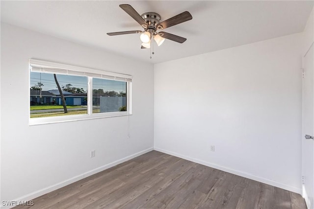 unfurnished room featuring ceiling fan, baseboards, and wood finished floors