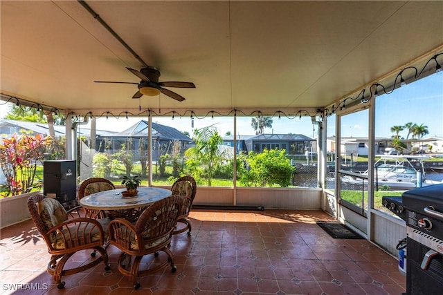 sunroom featuring ceiling fan