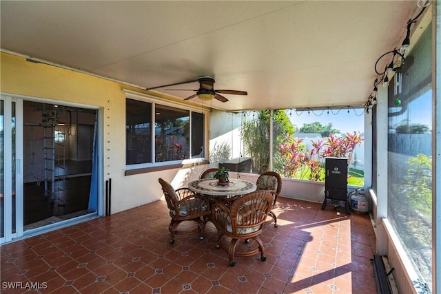 sunroom / solarium with a ceiling fan