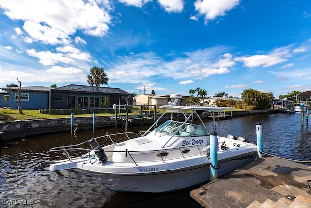 dock area featuring a residential view and a water view