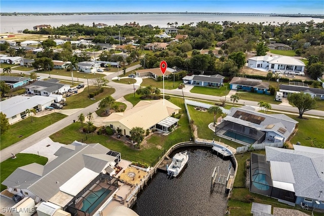 drone / aerial view with a water view and a residential view