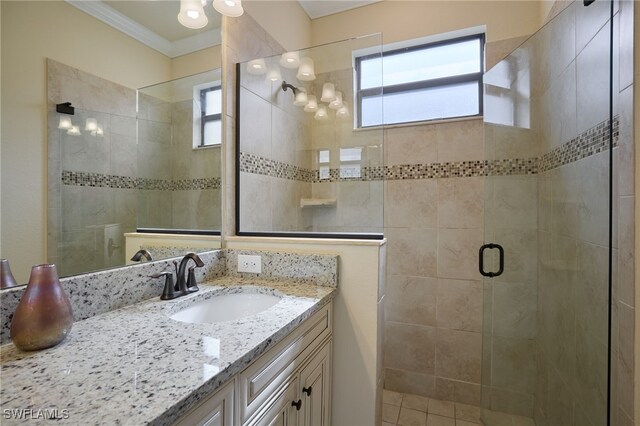 28074 Edenderry Ct, Bonita Springs, FL 34135 - full bathroom with a stall shower, vanity, crown molding, and healthy amount of natural light