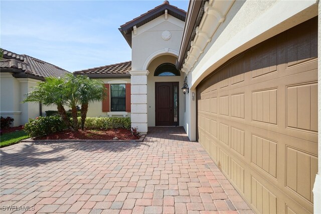 28074 Edenderry Ct, Bonita Springs, FL 34135 - property entrance featuring a tile roof and stucco siding