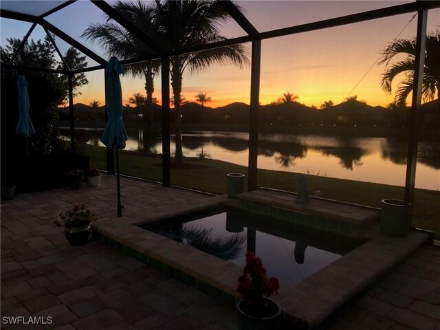 28074 Edenderry Ct, Bonita Springs, FL 34135 - view of patio with glass enclosure, an outdoor pool, and a water view