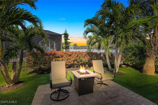 view of patio / terrace featuring a lanai and a fire pit