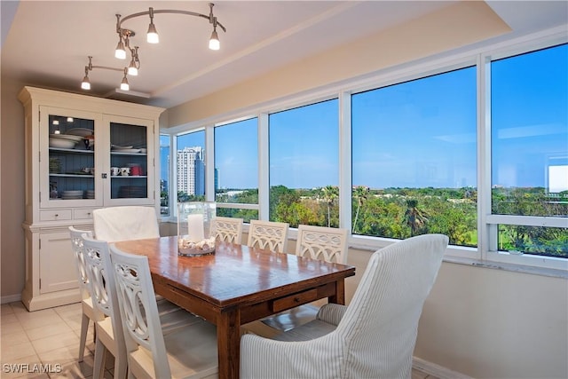 dining space with light tile patterned flooring and a wealth of natural light