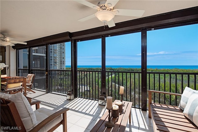 sunroom / solarium featuring a wealth of natural light and a ceiling fan