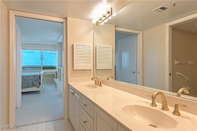 ensuite bathroom with visible vents, a sink, ensuite bath, and double vanity