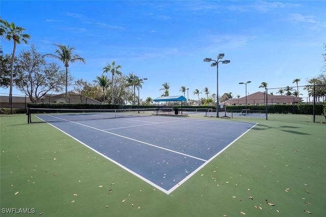 view of sport court featuring fence