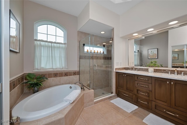 full bathroom with a sink, a bath, tile patterned floors, double vanity, and a stall shower