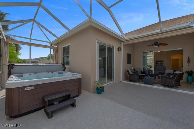 exterior space with stucco siding, a hot tub, an outdoor living space, and a patio