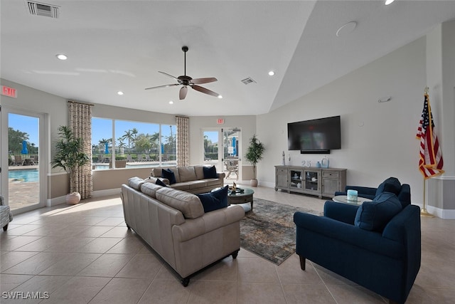 living room featuring lofted ceiling, visible vents, light tile patterned flooring, and recessed lighting