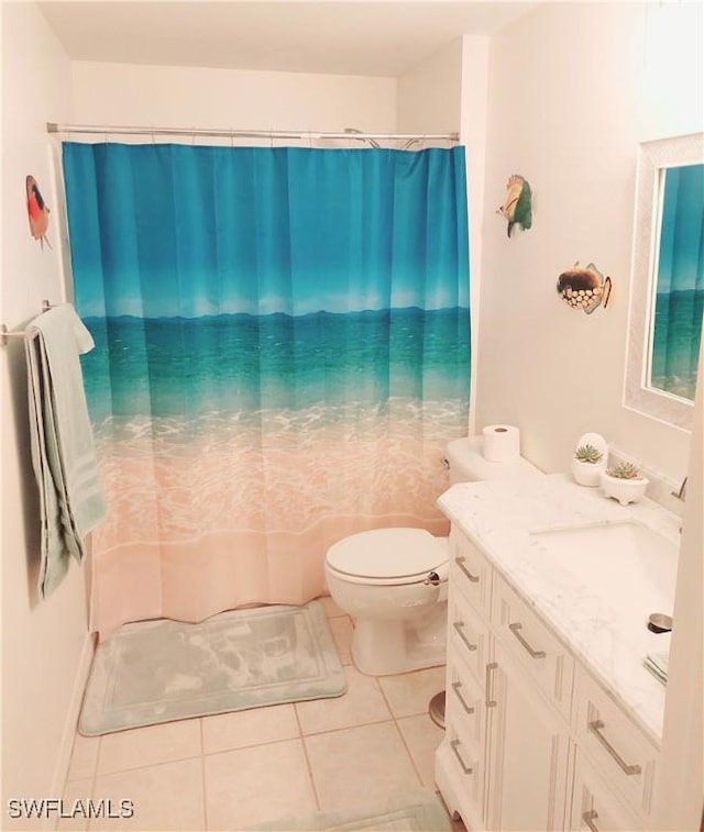 full bathroom featuring toilet, vanity, a shower with shower curtain, and tile patterned floors