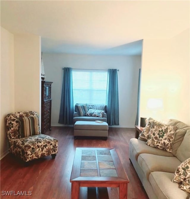 living area with wood finished floors and baseboards