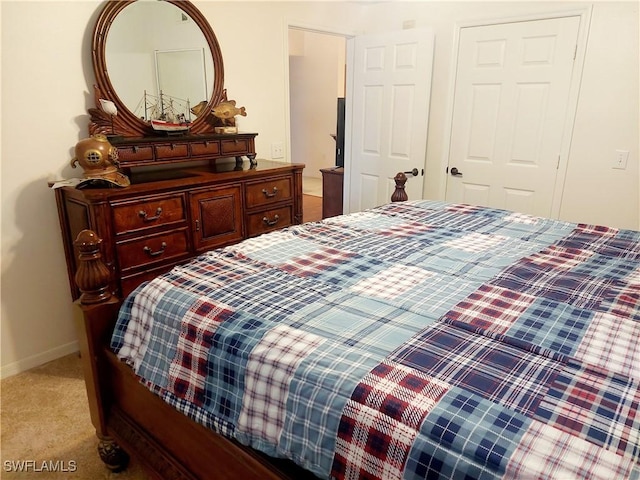 bedroom with light carpet and baseboards