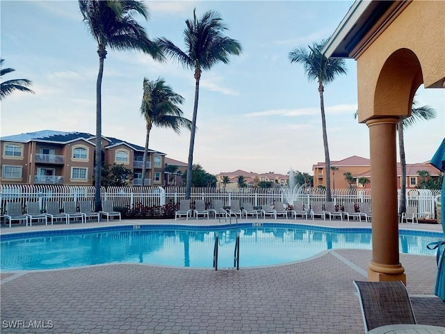 pool featuring a residential view, fence, and a patio