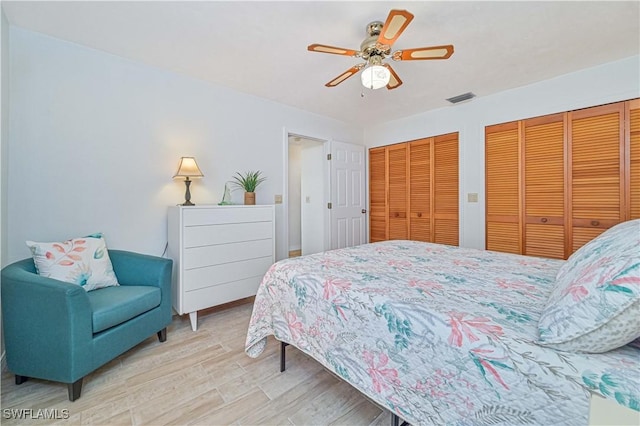 4145 Prestwick Ct, North Fort Myers, FL 33903 - bedroom featuring light wood-style flooring, visible vents, ceiling fan, and two closets
