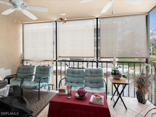 sunroom / solarium featuring a ceiling fan