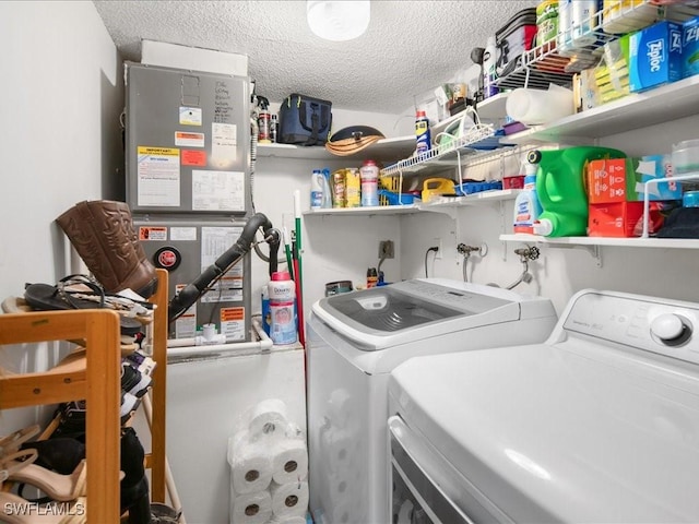 laundry area with laundry area, washer and clothes dryer, and a textured ceiling