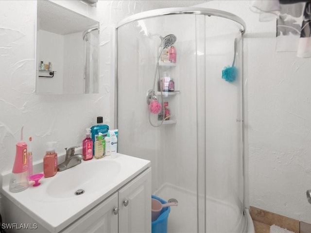 full bathroom featuring vanity and a shower stall