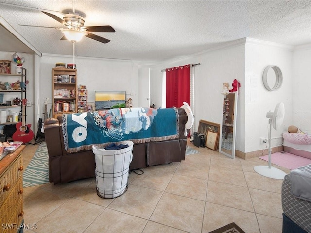 living area with light tile patterned floors, a textured ceiling, a ceiling fan, and crown molding