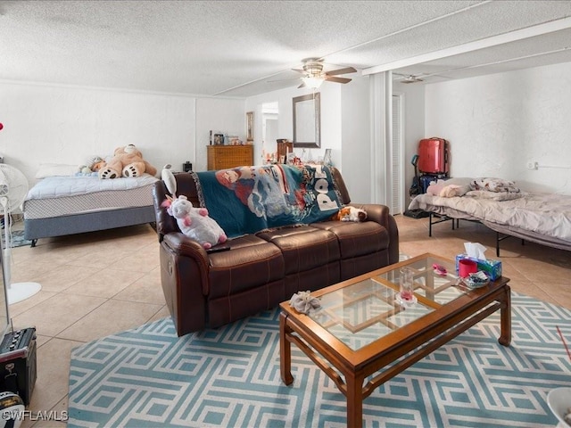 interior space featuring a ceiling fan, a textured ceiling, and light tile patterned floors